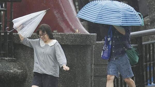 <div class="paragraphs"><p>People hold umbrellas as Typhoon Kong-rey approaches in Keelung, Taiwan. </p></div>