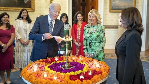 <div class="paragraphs"><p>United States President Joe Biden lights a lamp as First lady Jill Biden and Vice President Kamala Harris look on during an event to celebrate Diwali, at the White House in Washington, US in 2022.</p></div>
