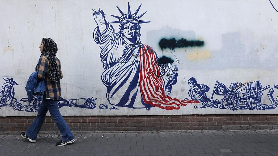 <div class="paragraphs"><p>An Iranian woman passes in front of an anti-US mural on a street in Tehran.</p></div>