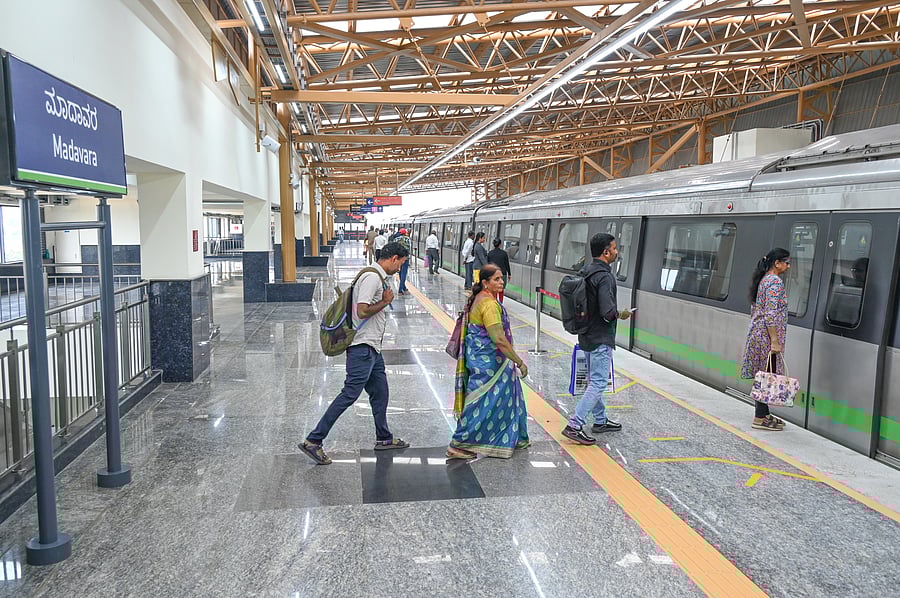 <div class="paragraphs"><p>Passengers board the metro train at the Madavara station on Thursday. </p></div>
