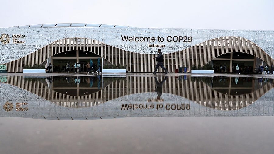 <div class="paragraphs"><p>People walk in front of the venue of the United Nations climate change conference COP29, in Baku, Azerbaijan </p></div>