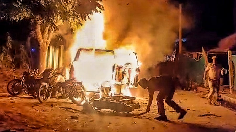<div class="paragraphs"><p> A vehicle set on fire during violence that erupted following clash between police and alleged supporters of independent candidate Naresh Meena, during Deoli-Uniara Assembly by-poll, at Samravta village in Tonk district of Rajasthan, Wednesday, Nov. 13, 2024. </p></div>