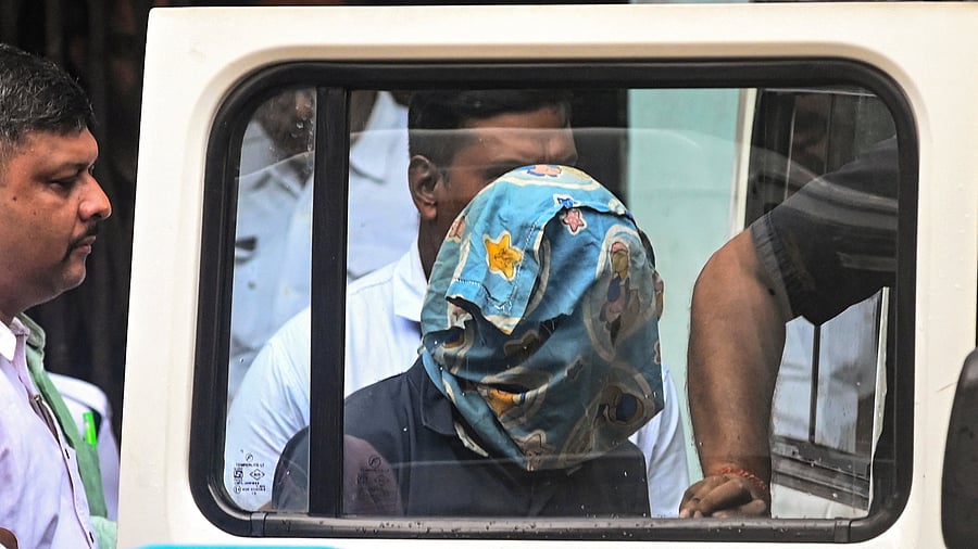 <div class="paragraphs"><p>Police personnel produce the accused arrested in connection with the alleged rape and murder of a woman trainee doctor at RG Kar Medical College and Hospital, at a City Court in Kolkata </p></div>