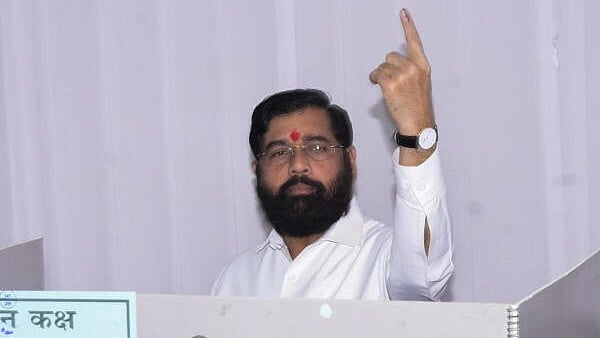 <div class="paragraphs"><p>Maharashtra Chief Minister Eknath Shinde shows his ink-marked finger after casting vote during the state Assembly elections, in Thane on Wednesday.</p></div>