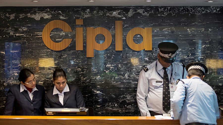 <div class="paragraphs"><p> Employees and security staff work at the reception area of Cipla at its headquarters in Mumbai</p></div>