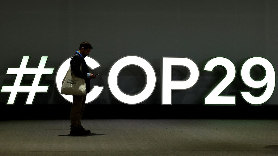 <div class="paragraphs"><p>A man stands next to the logo of the COP29 United Nations climate change conference, in Baku, Azerbaijan.</p></div>