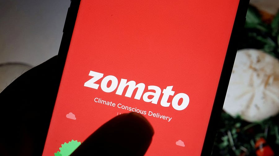 <div class="paragraphs"><p>The logo of food delivery company Zomato is seen on its app on a mobile phone displayed in front of its company website in this illustration picture taken July 14, 2021. </p></div>