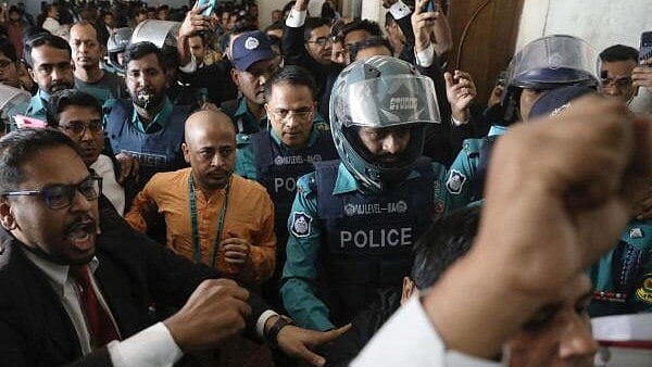 <div class="paragraphs"><p>Chinmoy Krishna Das, a Hindu leader associated with ISKCON being escorted by the police at the Chattogram Metropolitan Magistrate Court, in Chattogram. </p></div>