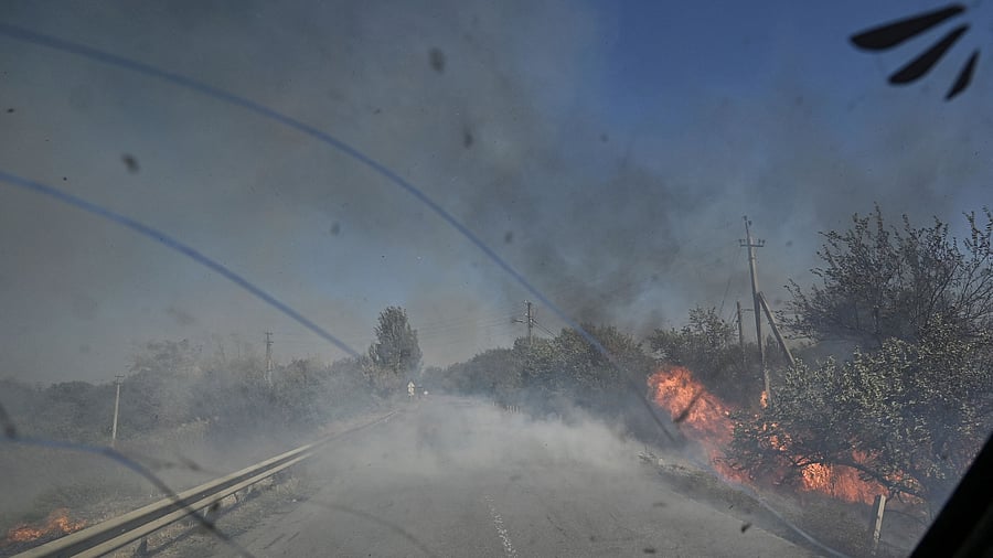 <div class="paragraphs"><p>A police officer drives a vehicle past burning trees during an evacuation of civilians from the outskirts of the Kurakhove town, amid Russia's attack on Ukraine, in Donetsk region, Ukraine</p></div>