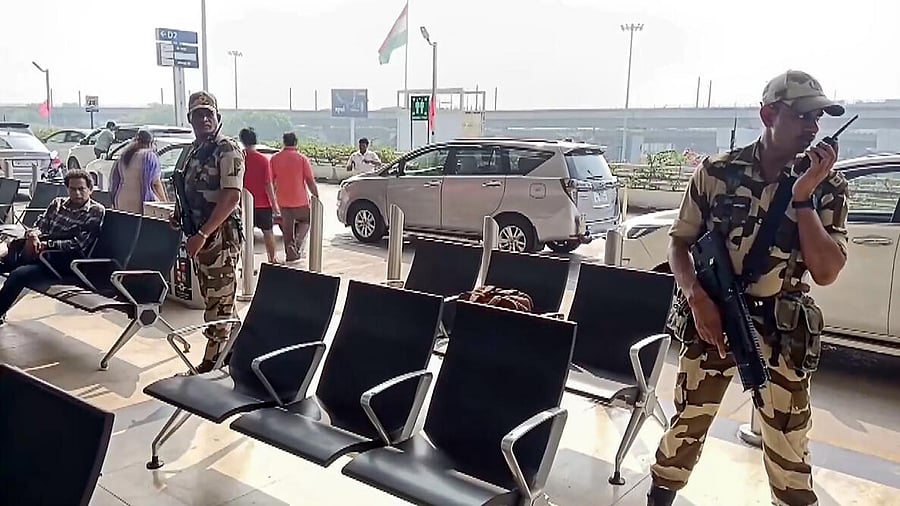 <div class="paragraphs"><p>Security personnel stand guard at the airport after a Kolkata-bound IndiGo flight received bomb threat, in Chennai. </p></div>