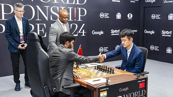 <div class="paragraphs"><p>India's D Gukesh, left, and Ding Liren of China during their match at the FIDE World Championship 2024, in Singapore, Wednesday, Nov. 27, 2024.</p></div>
