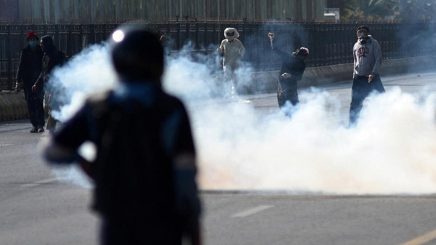 <div class="paragraphs"><p>A supporter of the jailed former Pakistani Prime Minister Imran Khan's party Pakistan Tehreek-e-Insaf (PTI) throws an object towards security force personnel during a protest rally demanding Khan's release, in Islamabad, Pakistan, November 26, 2024.</p></div>
