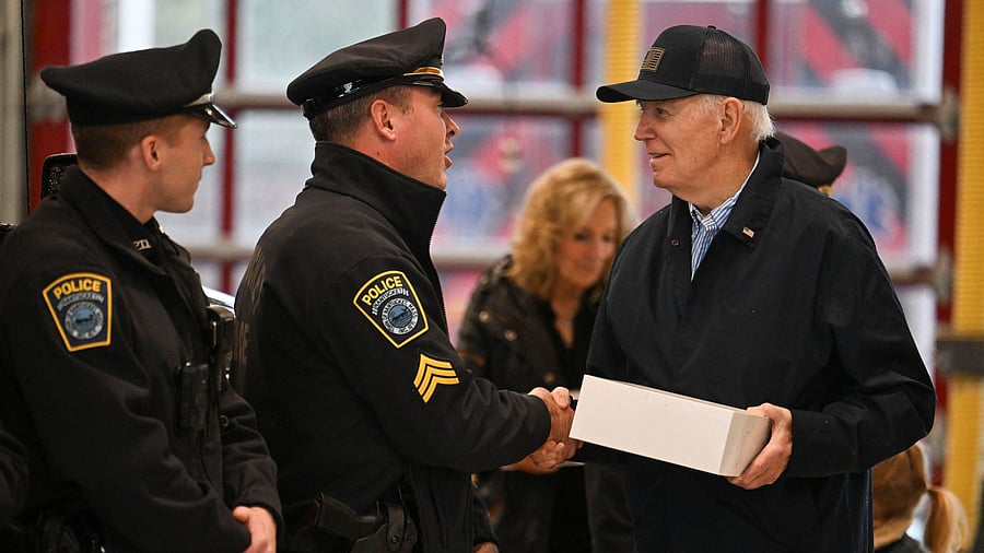 <div class="paragraphs"><p>US President Joe Biden, accompanied by first lady Jill Biden and their grandson Beau Jr., greets police personnel as they deliver pumpkin pies at the Nantucket Central Fire Station in Nantucket, Massachusetts, US, on Thanksgiving Day, November 28.</p></div>