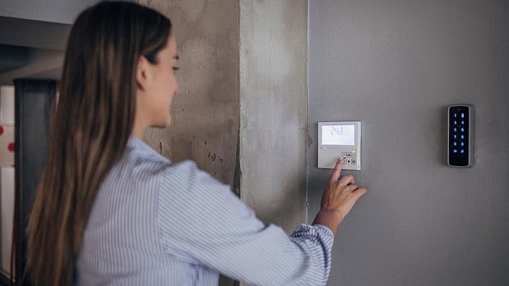 <div class="paragraphs"><p>Representative image of an AC remote on a wall in an office.</p></div>