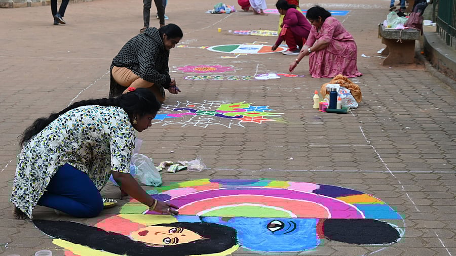 <div class="paragraphs"><p>Women create intricate rangolis at a competition held by the Cubbon Park Walkers’ Association and the Department of Horticulture, celebrating Kannada Rajyotsava in Bengaluru on Saturday.</p></div>