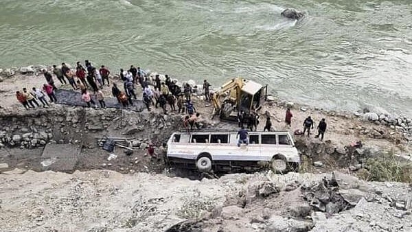 <div class="paragraphs"><p>People gather near an overturned bus after it fell into a gorge on the bank of the Teesta river near Rangpo border, in Pakyong district, Sikkim, on Saturday.</p></div>