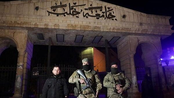 <div class="paragraphs"><p>Syrian opposition fighters stand in front of University of Aleppo, after rebels opposed to Syria's President Bashar al-Assad said they had reached the heart of Aleppo, Syria November 30, 2024.</p></div>