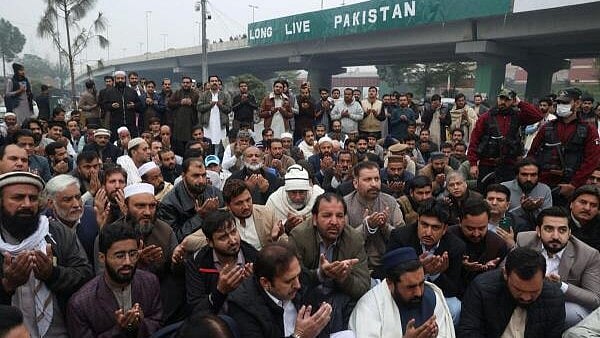 <div class="paragraphs"><p>Supporters of the former Pakistani Prime Minister Imran Khan's party, Pakistan Tehreek-e-Insaf (PTI), attend a symbolic prayer for the people the party claims were killed during a protest in Islamabad this week in Peshawar.</p></div>
