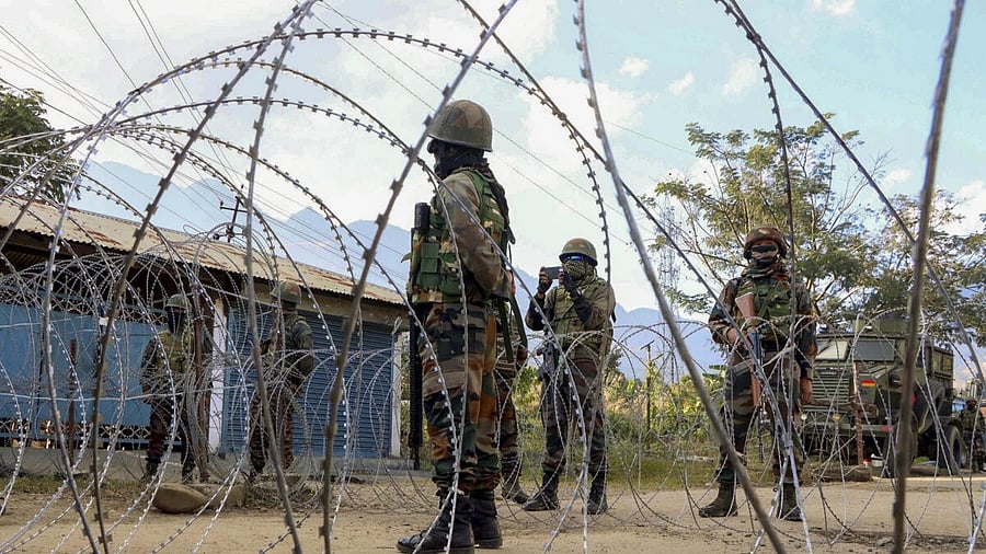 <div class="paragraphs"><p>Security personnel stand guard during a protest at Leimakhong, in Kangpokpi district, Manipur.</p></div>