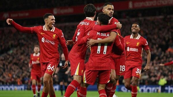 <div class="paragraphs"><p>Liverpool's Cody Gakpo celebrates scoring their first goal with Mohamed Salah and Dominik Szoboszlai.</p></div>