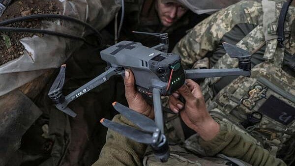 <div class="paragraphs"><p>A Ukrainian serviceman holds a drone, to be used to fly over the positions of Russian troops at a frontline in the Donbas region. </p></div>
