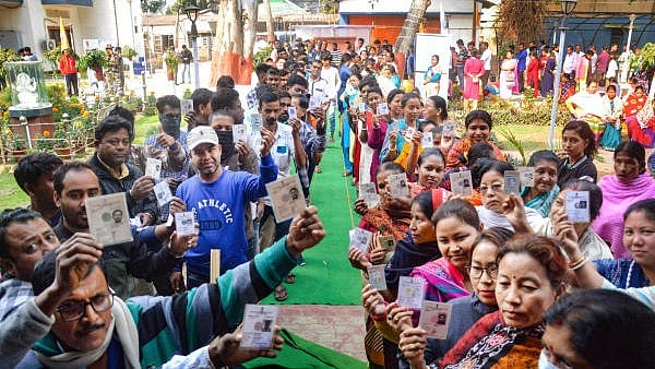 <div class="paragraphs"><p>Voters show their identification cards as they wait in queues to cast their votes at a polling booth during the Tripura Assembly elections</p></div>