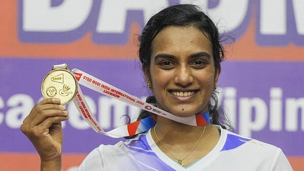 <div class="paragraphs"><p>Badminton player P V Sindhu displays her gold medal as she poses for photographs after winning the final match against WU Luo Yu of China at Syed Modi India International Badminton Championship at BBD Badminton Academy, in Lucknow.&nbsp;</p></div>