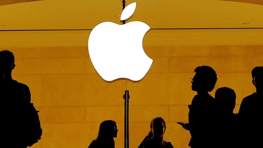 <div class="paragraphs"><p>Customers walk past an Apple logo inside of an Apple store.</p></div>