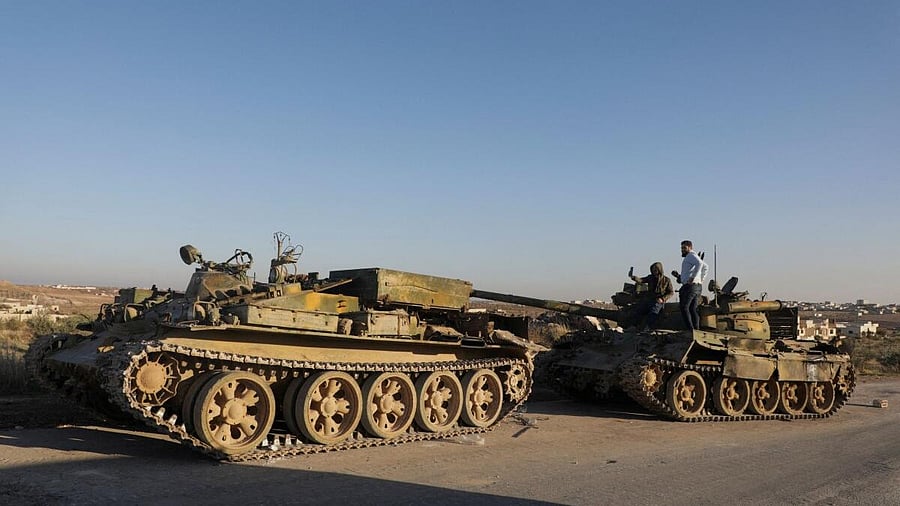 <div class="paragraphs"><p>Men stand on a military vehicle in the city of Maarat al-Numan, in Idlib province</p></div>