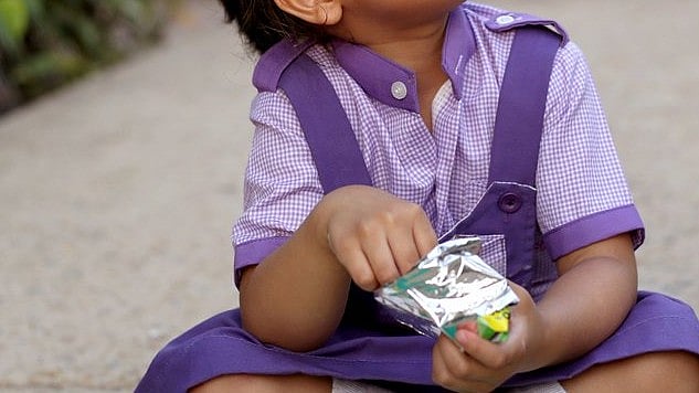 <div class="paragraphs"><p>Representative image of a kid with a nutritional snack packet.&nbsp;</p></div>
