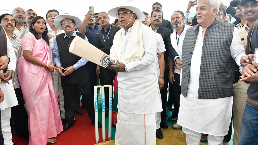 <div class="paragraphs"><p>With former Karnataka Ranji player and ex-Congress MLC Prakash Rathod beside him, Chief Minister Siddaramaiah tries his hand at batting during the bhoomi puja for a world-class cricket stadium at P Gollahalli in Tumakuru taluk on Monday. Ministers G Parameshwara and K N Rajanna and MLC K Govindaraju are also seen.</p></div>