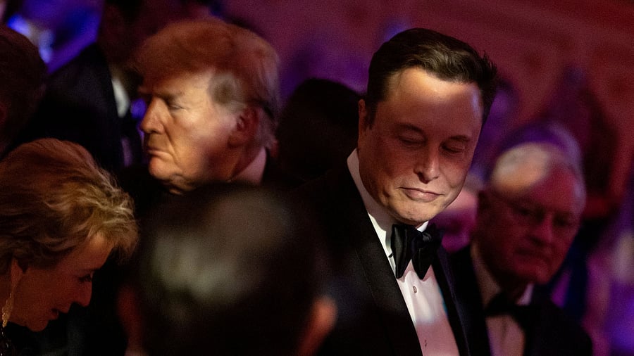 <div class="paragraphs"><p>US President-elect Donald Trump walks by Elon Musk.</p></div>