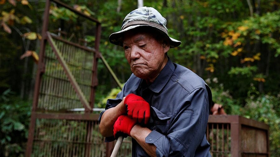 <div class="paragraphs"><p>Hunter Katsuo Harada, 84, stands in front of a bear trap set in Iwamizawa, Hokkaido Prefecture, Japan.</p></div>