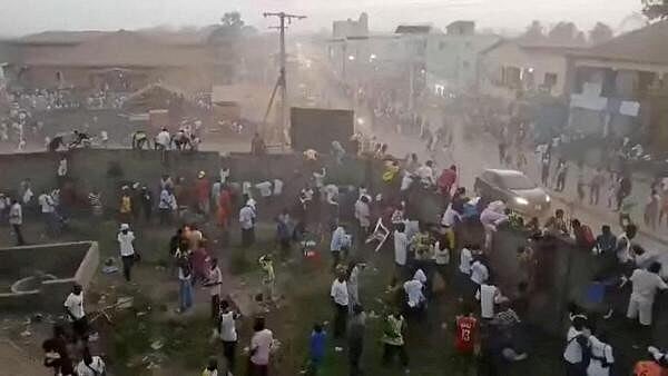 <div class="paragraphs"><p>People scramble in Nzerekore, Guinea, where local officials said a deadly crush ensued at a stadium following fan clashes during a soccer match</p></div>