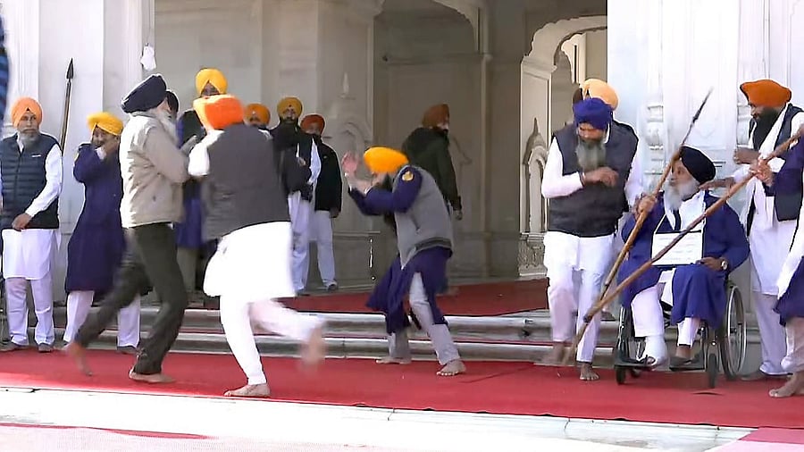 <div class="paragraphs"><p>People catch a man who allegedly opened fire at Shiromani Akali Dal leader Sukhbir Singh Badal while the latter was serving the 'tankhah' (religious punishment) given by the Akal Takht at the Golden Temple, in Amritsar.</p></div>