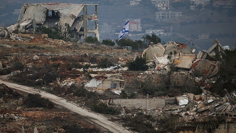 <div class="paragraphs"><p>An Israeli flag flutters as buildings lie in ruin in Lebanon, near the Israel-Lebanon border.</p></div>