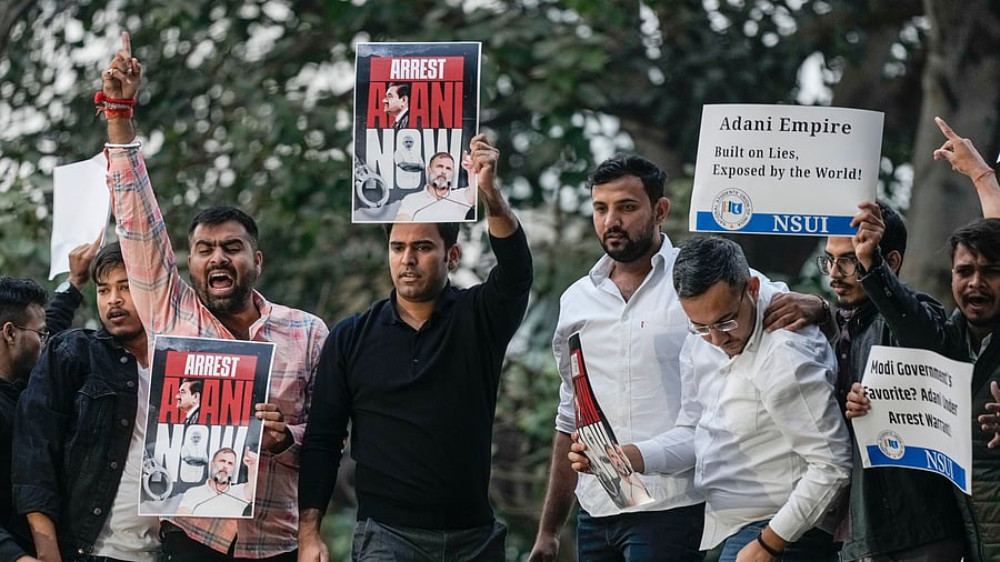 <div class="paragraphs"><p>File Photo: NSUI members stage a protest demanding the arrest of industrialist Gautam Adani after he was charged in the US for alleged bribery and fraud, in New Delhi.</p></div>