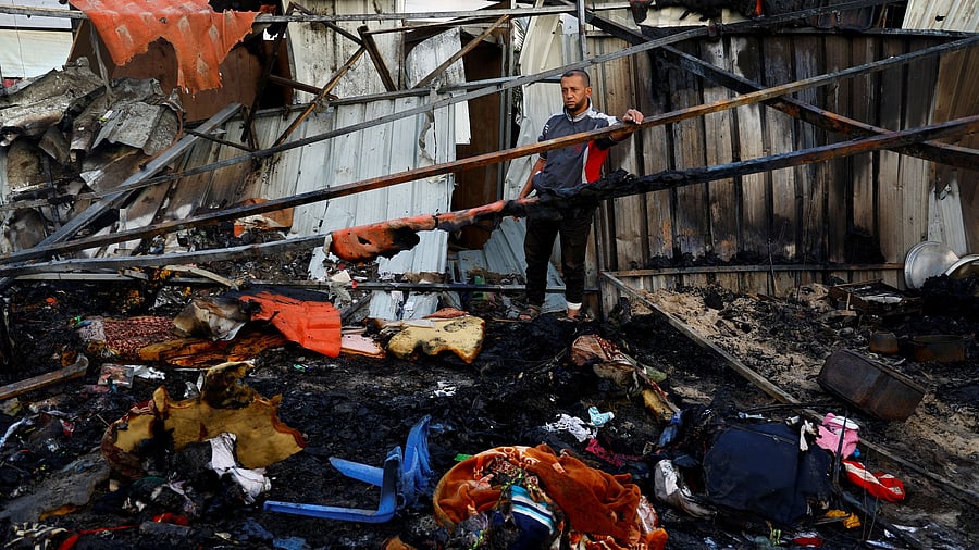 <div class="paragraphs"><p>A Palestinian man inspects the damage in the aftermath of an Israeli strike on a tent camp, in Khan Younis in the southern Gaza Strip December 5, 2024.</p></div>