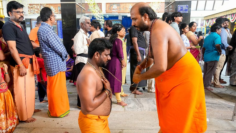 <div class="paragraphs"><p>A devotee receives prayer beads from a priest during rituals at a temple. (Image for representation)</p></div>