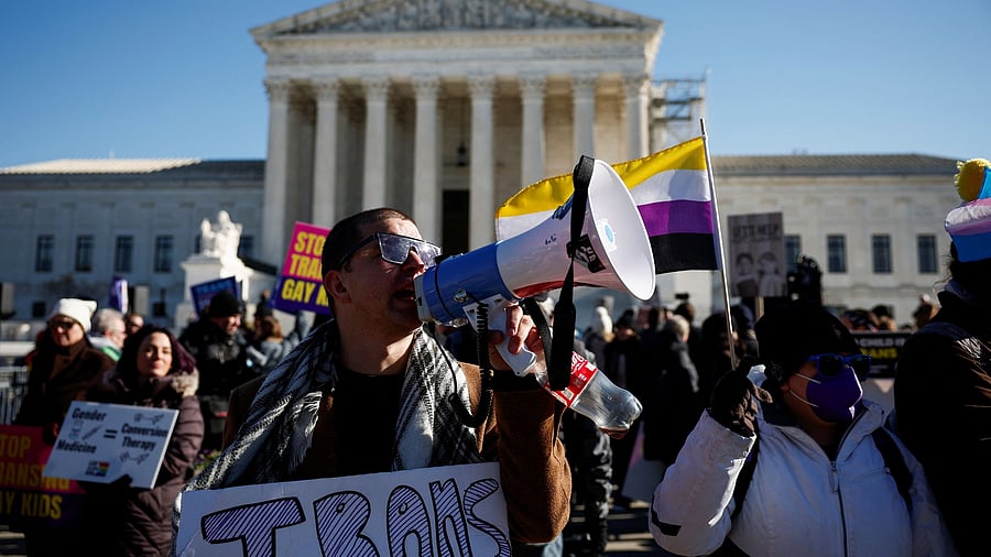 <div class="paragraphs"><p>Derek Torstenson uses a megaphone while holding a sign at a demonstration, as the U.S. Supreme Court hears arguments over an appeal by US President Joe Biden's administration of a lower court's decision upholding a Republican-backed ban in Tennessee on gender-affirming medical care for transgender minors, outside the court in Washington, U.S. </p></div>