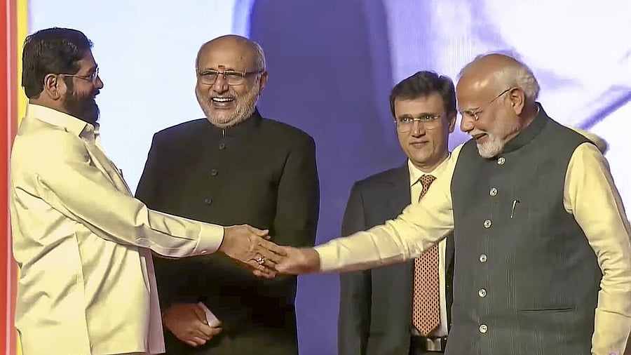 <div class="paragraphs"><p>Prime Minister Narendra Modi being greeted by newly-sworn Maharashtra Deputy Chief Minister Eknath Shinde during the swearing-in ceremony, in Mumbai</p></div>