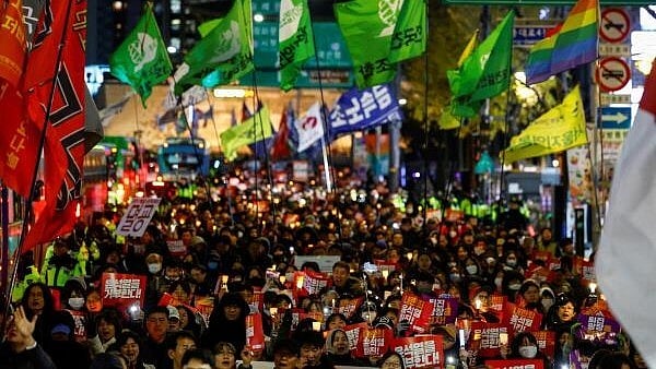 <div class="paragraphs"><p>People protest during a candlelight vigil calling for the resignation of South Korean President Yoon Suk Yeol, in Seoul.</p></div>