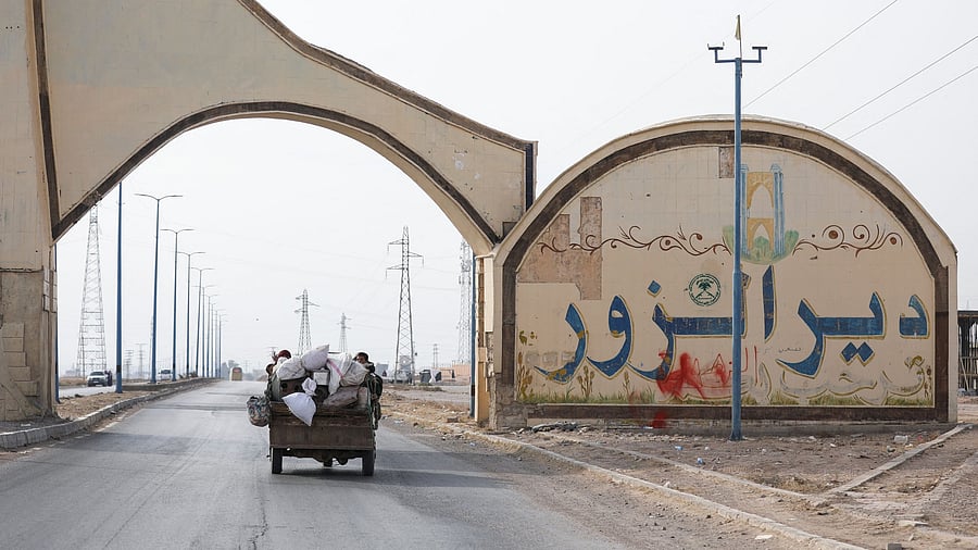 <div class="paragraphs"><p>People ride on a vehicle in Deir al-Zor, after US-backed alliance led by Syrian Kurdish fighters captured Deir el-Zor.</p></div>