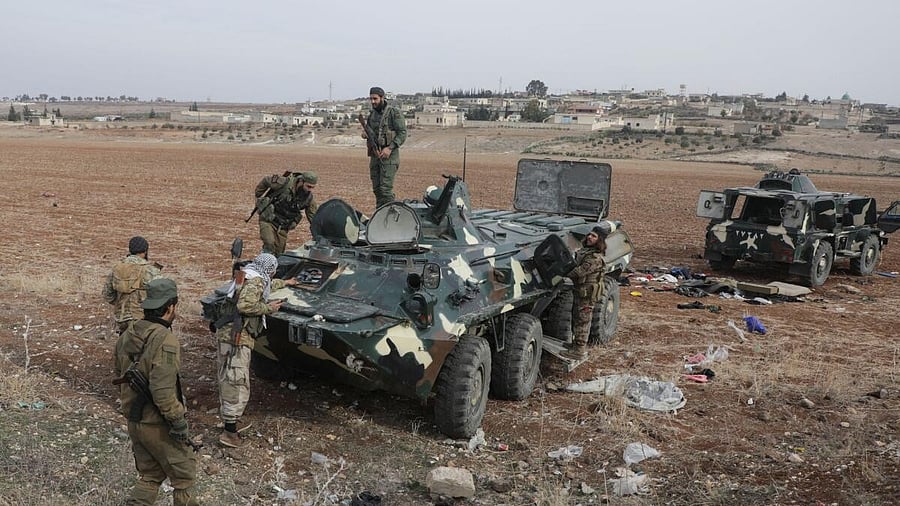 <div class="paragraphs"><p>A rebel fighter stands on a military vehicle in Homs countryside,</p></div><div class="paragraphs"><p></p></div>