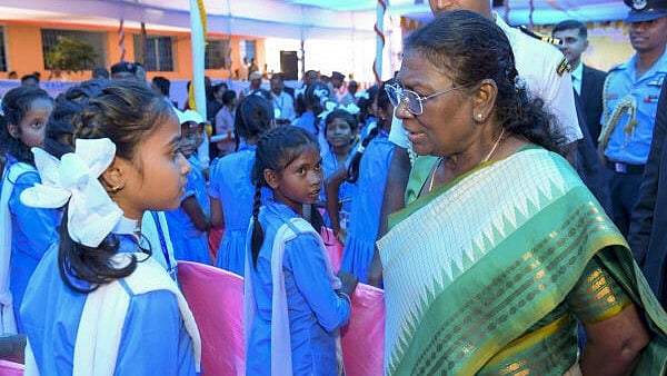 <div class="paragraphs"><p>President Droupadi Murmu interacts with school students during a visit to her alma mater, Uparbeda Government Upper Primary School, at her birthplace Uparbeda village, in Mayurbhanj district, Odisha.</p></div>