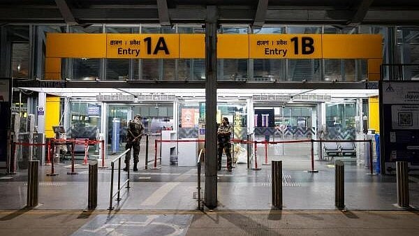 <div class="paragraphs"><p>Central Industrial Security Force (CISF) officials stand outside the departure gates of a  Netaji Subhas Chandra Bose International&nbsp;Airport</p></div>