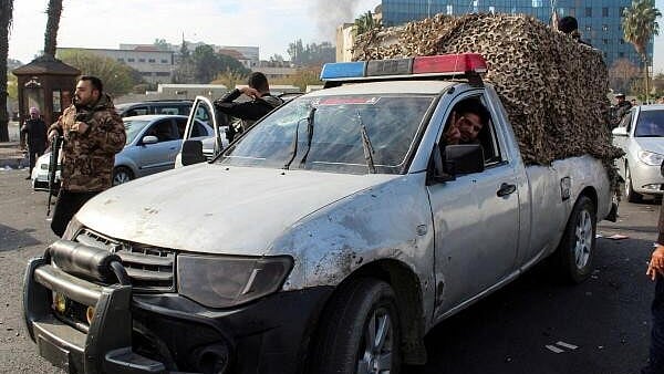 <div class="paragraphs"><p>A man gestures from a vehicle as people celebrate after Syrian rebels announced that they have ousted President Bashar al-Assad, in Damascus, Syria.&nbsp;</p></div>