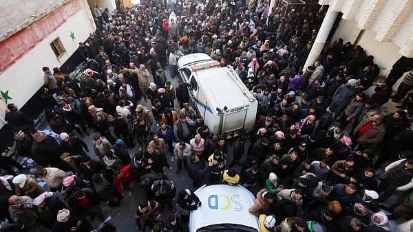 <div class="paragraphs"><p>People gather as members of the Syrian civil defence group, known as the White Helmets, search for prisoners underground at Sednaya prison, after rebels seized the capital and announced that they have ousted President Bashar al-Assad in Sednaya, Syria.&nbsp;</p></div>