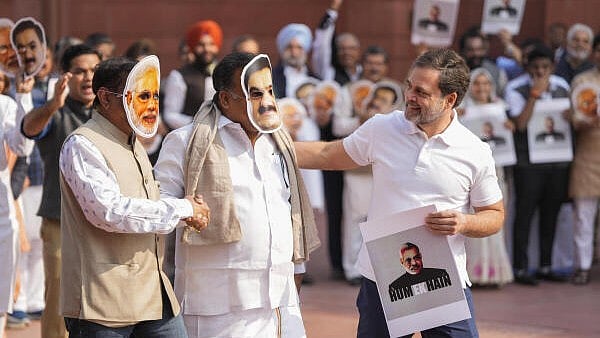 <div class="paragraphs"><p>Leader of Opposition in the Lok Sabha Rahul Gandhi, right, with Congress MPs Manickam Tagore and Saptagiri Sankar Ulaka, wearing face masks of Prime Minister Narendra Modi and Adani Group Chairman Gautam Adani, at a protest during the Winter session of Parliament, in New Delhi, on Monday.</p></div>