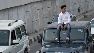 <div class="paragraphs"><p>Teen vlogger Rakshit Beniwal sitting on the roof of a moving car</p></div>